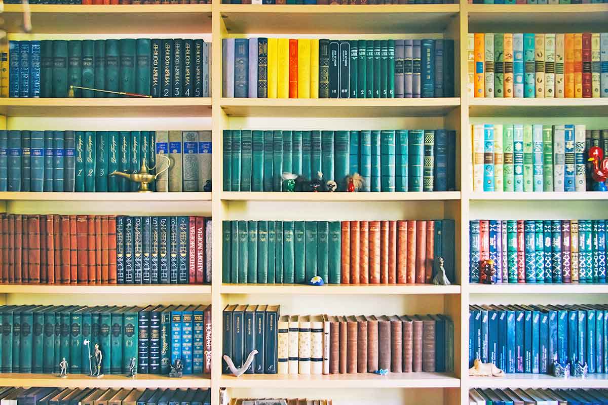 A bookshelf filled with lots of books and papers.